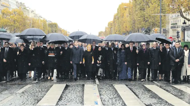  ??  ?? Leaders walk toward the Arc de Triomphe in Paris, France, as part of the commemorat­ions marking the 100th anniversar­y of the Armistice of 11 November 1918.