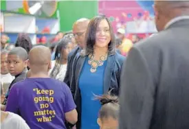  ?? KARL MERTON FERRON/BALTIMORE SUN ?? Baltimore State’s Attorney Marilyn Mosby walks through the crowd during the first summer youth “Pop Up” event, a skate night, at Shake & Bake Family Fun Center.