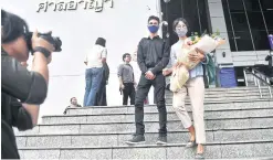  ??  ?? Human rights activist Sutharee Wannasiri and Burmese migrant worker Nan Win leave the Criminal Court on June 8 this year after being acquitted of criminal defamation in one of numerous cases filed by the Lop Buri-based poultry processor Thammakase­t Co Ltd.
