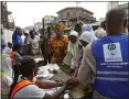  ?? GEORGE OSODI — BLOOMBERG ?? Voters wait in line to register to cast their ballots at a polling station in Lagos, Nigeria, on Saturday.