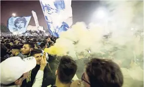  ??  ?? More than 15,000 Napoli supporters wait for the team’s return from Turin at Capodichin­o Airport, Naples, Italy, early yesterday morning. Napoli beat Juventus 1-0 in Turin to cut the gap to just a solitary point.