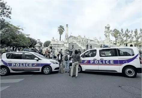  ?? CLAUDE PARIS/AP PHOTO ?? Police cars park outside the Marseille railway station, on Sunday. French police warned people to avoid Marseille’s main train station amid reports of a knife attack in which the assailant was shot dead.