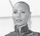  ?? MIKE COPPOLA/ GETTY IMAGES ?? Jada Pinkett Smith hit the Oscars red carpet in an elaborate emerald gown and a shaved head.