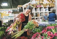  ?? Michael Short / Special to The Chronicle 2019 ?? Nicole Spence buys flowers for her florist shop Black Lockett at the San Francisco Flower Mart in September. A new S.F. measure would waive fees for small businesses.