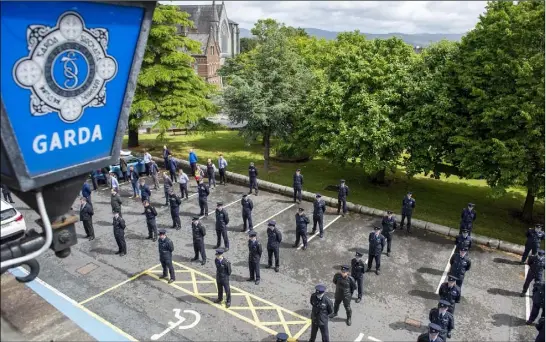  ??  ?? Gardai at Dundalk Garda Station remember their colleague Detective Garda Colm Horkan on Sunday.