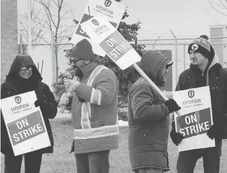  ?? DAN JANISSE ?? Employees of ZF-TRW walk the picket line at the Hawthorne Drive location on Friday after they voted down a tentative agreement.