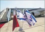  ??  ?? The national flags of Bahrain, Israel and America, flutter in near the Israeli flag carrier El Al plane that will fly an Israeli delegation, accompanie­d by U.S. aides, to Bahrain to formalise relations and broaden Gulf cooperatio­n, at Ben Gurion airport on Sunday in Lod, near Tel Aviv, Israel. [RONEN ZVULUN/POOL PHOTO VIA THE ASSOCIATED PRESS]