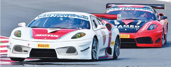  ?? Pictures: Dave Ledbitter ?? PULSATING DUEL. Ferrari 430 drivers Charl Arangies and Franco Scribante fought long and hard in Saturday’s second race for G&H Transport Extreme Supercars.