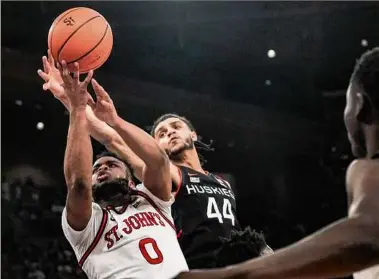  ?? Bebeto Matthews / Associated Press ?? St. John's guard Posh Alexander, left, drives to the basket against UConn guard Andre Jackson Jr. during the second half. Jackson had 15 points as UConn won for the sixth time in seven games.