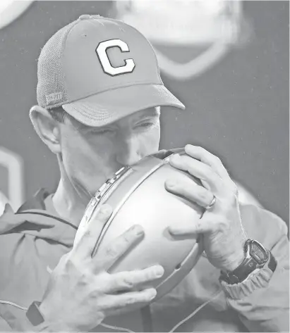  ?? JEREMY BREVARD/USA TODAY SPORTS ?? Coach Dabo Swinney kisses the ACC championsh­ip trophy after Clemson defeated Pittsburgh 42-10 Saturday at Bank of America Stadium in Charlotte, North Carolina.