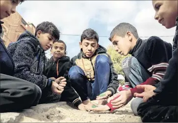  ?? Said Khatib AFP/Getty Images ?? YOUNG refugees at the Rafah camp in Gaza. Much of U.S. funding for Palestinia­ns goes to the U.N. agency that aids Palestinia­n refugees, and almost everyone in the camps relies on the services the agency provides.