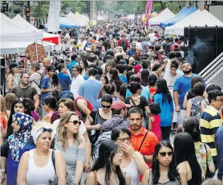  ?? JOHN MAHONEY ?? Shoppers fill Montreal’s Ste-Catherine St. west of Peel St. on Sunday during the three-day sidewalk sale and street festival billed as the ‘biggest open sky gathering of merchants in Canada.’