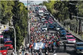  ?? AP PHOTO/REBECCA BLACKWELL ?? A group of Central American migrants, representi­ng the thousands participat­ing in a caravan trying to reach the U.S. border, undertake an hours-long march to the office of the United Nations’ human rights body in Mexico City on Thursday.