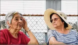  ?? THE BLADE/JETTA FRASER ?? Marta Salinas (left) and Tina Silva enjoy sitting outside and chatting in their Toledo neighborho­od — and watching out for each other.