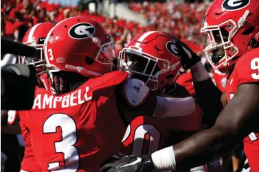  ?? Joshua L. Jones/Athens Banner-Herald via AP ?? ■ Georgia defensive back J.R. Reed (20) celebrates with teammates after scoring a touchdown against Murray State on Sept. 7 in Athens, Ga.