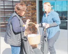  ??  ?? Horizons traffic safety officer Debbie Webster outside Dannevirke New World Supermarke­t gives a shopping bag and other goodies to Fiona van Duin as a reminder to keep safe on railway tracks.