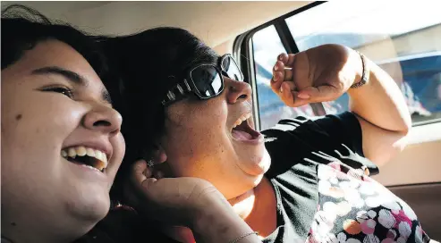  ??  ?? Lulu Quintana-Salazar, left, and her mother, Lourdes Salazar Bautista, 49, laugh as they drive to visit family in the country in San Nicolas Solis, Mexico.