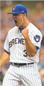  ?? JEFF HANISCH / USA TODAY SPORTS ?? Brewers reliever Dan Jennings celebrates after shutting down a Braves rally in the seventh inning.