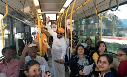  ??  ?? People from different walks of life and nationalit­ies en route to Global Village in a ‘happiness bus’ arranged by the RTA.