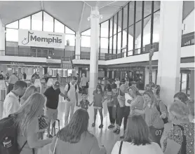  ?? DR. TIM PANGONAS ?? The Memphis team gathers in prayer at Memphis Internatio­nal Airport before leaving to assist at the Humanitari­an Respite Center in McAllen, Texas.