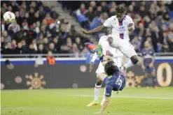  ??  ?? DECINES: Paris Saint Germain’s Edinson Roberto Cavani, down, challenges for the ball with Lyon’s Mapou Yanga Mbiwa, up, during their French League One soccer match in Decines, near Lyon, central France, Sunday. — AP