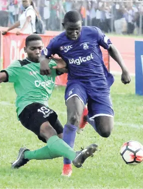  ?? FILE ?? Kingston College’s (KC) Damion Williams (right) is tackled by Calabar’s Andre Channer during their ISSA/Digicel Manning Cup encounter on September 18. KC won 3-0..