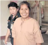  ?? PORNPROM SATRABHAYA ?? Amporn ‘Khru Khaek’ Jaikorn in a prison uniform smiles after the Min Buri Provincial Court acquitted the red-shirt supporter of charges of involvemen­t in a bomb blast in Min Buri district of Bangkok that killed two people in 2014.