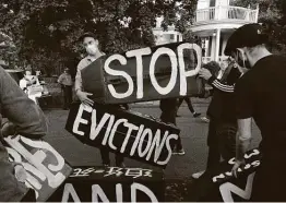  ?? Michael Dwyer / Associated Press file photo ?? Housing activists erect a sign in front of Massachuse­tts Gov. Charlie Baker’s house during an October protest in Swampscott.