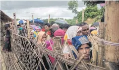  ?? AFP ?? Rohingya refugees queue at an aid relief distributi­on centre at the Balukhali refugee camp near Cox’s Bazaar.