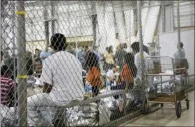  ?? U.S. CUSTOMS AND BORDER PROTECTION’S RIO GRANDE VALLEY SECTOR VIA THE ASSOCIATED PRESS ?? On June 17, people who’ve been taken into custody related to cases of illegal entry into the United States sit in one of the cages at a facility in McAllen, Texas. Immigrant children described hunger, cold and fear in a voluminous court filing about the facilities where they were held in the days after crossing the border. Advocates fanned out across the southwest to interview more than 200 immigrant parents and children about conditions in U.S. holding facilities, detention centers and a youth shelter.