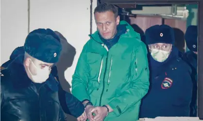  ?? Photograph: Sergei Ilnitsky/EPA ?? Alexei Navalny (centre) is escorted out of a police station in Khimki, outside Moscow, Russia. He will remain in custody for 30 days.