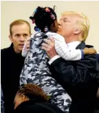  ?? THE ASSOCIATED PRESS ?? President Donald Trump meets people who fled Hurricane Harvey during a visit Saturday to the NRG Center in Houston.