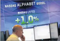 ?? AP PHOTO/MARK LENNIHAN ?? In this Feb. 1, 2016, file photo, electronic screens post the price of Alphabet stock at the Nasdaq MarketSite in New York. Google parent Alphabet is taking a $2.7 billion write-down to cover a large fine EU antitrust enforcers assessed in June 2017.