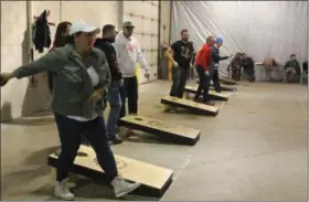  ?? LAUREN HALLIGAN — DIGITAL FIRST MEDIA ?? Event-goers play cornhole during the first-ever Cornhole For a Cure tournament on Sunday afternoon at Racing City Brewing Company in Saratoga Springs.