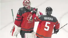  ?? THE CANADIAN PRESS ?? Team Canada goalie Carter Hart and defenceman Josh Mahura, a member of the WHL’s Regina Pats, celebrate a victory over the Czech Republic in world junior pre-tournament action on Wednesday.