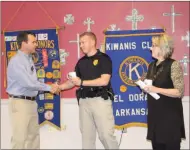  ??  ?? Academy: President of the El Dorado Kiwanis Club, Jeffrey Sawyer, left, gives Kiwanis coffee mugs to guest speakers police officer Gerid Ardwin and Deb Crawford. Ardwin and Crawford spoke about a new program that will begin this summer called the CATS...