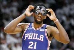  ?? JOE SKIPPER — THE ASSOCIATED PRESS ?? Philadelph­ia 76ers center Joel Embiid (21) adjusts his mask in the third quarter of play against the Miami Heat in Game 4 of a first-round NBA basketball playoff series, Saturday.
