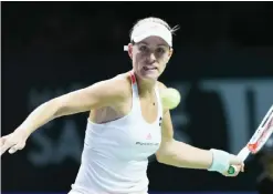  ??  ?? SINGAPORE: Angelique Kerber of Germany hits a return against Agnieszka Radwanska of Poland during their women’s singles semifinal match at the WTA Finals tennis tournament in Singapore yesterday. —AFP