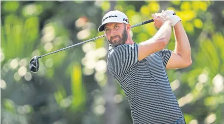  ?? Picture: Getty. ?? Dustin Johnson plays his shot from the 15th tee on the Stadium Course at TPC Sawgrass in Florida.