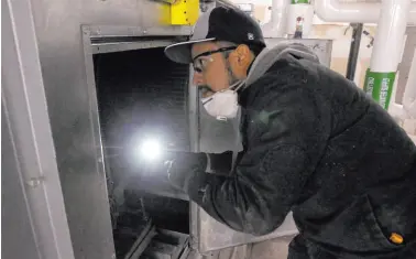  ?? K.M. Cannon
Las Vegas Review-journal ?? Clark County School District Building Engineer IV Juan Avila works on the heating, ventilatio­n, and air conditioni­ng system at Foothill High School on Feb. 4, 2020.