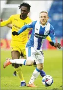  ??  ?? CLASH: Anthony Stewart, left, tracks Huddersfie­ld’s Alex Pritchard