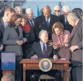  ?? ALEX WONG/GETTY ?? President Joe Biden talks to Speaker of the House Nancy Pelosi after signing the Infrastruc­ture Investment and Jobs Act on Nov. 15 at the White House.