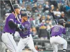  ?? Andy Cross, The Denver Post ?? Shortstop Trevor Story, center, joins third baseman Nolan Arenado, left, and right fielder Charlie Blackmon as providing the power for the Rockies this season.