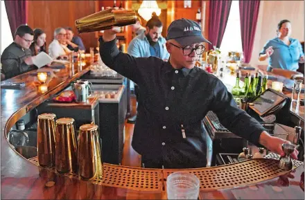  ?? SEAN D. ELLIOT/ THE DAY ?? Beverage manager Jade Ayala mixes a drink at The Port of Call in Mystic.