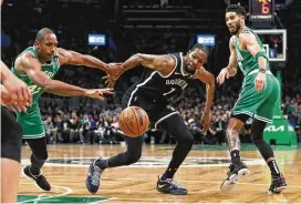  ?? MICHAEL DWYER/ASSOCIATED PRESS ?? Brooklyn Nets’ Kevin Durant (center) battles for the ball with Boston Celtics’ Al Horford and Jayson Tatum during the first half of Game 2 of their first-round Eastern Conference playoff series, Wednesday in Boston.