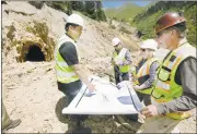  ?? JERRY MCBRIDE/ DURANGO HERALD ?? Engineers and state leaders from Utah and Colorado go over a map of mine shafts in the mountain near the Gold King Mine in Colorado, where a cleanup team triggered a catastroph­ic spill on Aug. 5.