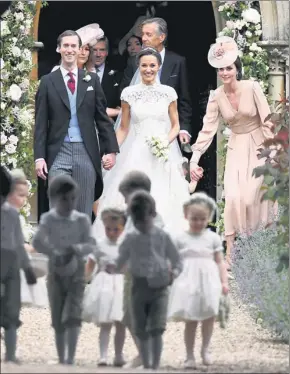  ?? JUSTIN TALLIS / REUTERS ?? Pippa Middleton (center) and James Matthews leave the church after their wedding, with the Duchess of Cambridge (right) walking behind with daughter Princess Charlotte.