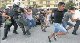  ?? Picture: REUTERS ?? OBJECTING: Protesters run to escape arrest during clashes with riot police in the courtyard of the defence ministry in Athens yesterday.