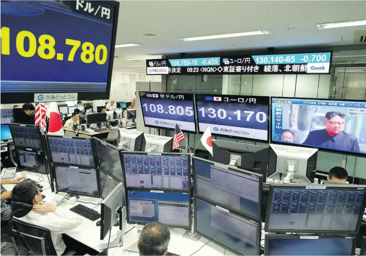  ?? KAZUHIRO NOGI / AFP / GETTY IMAGES ?? A TV at a foreign exchange brokerage in Tokyo displays file news footage of North Korean leader Kim Jong Un after a missile was launched by North Korea and flew over Japan.