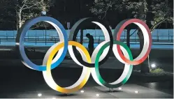  ?? JAE C. HONG/ASSOCIATED PRESS ?? The Olympic rings Tuesday in front of the New National Stadium in Tokyo. IOC President Thomas Bach has agreed to a proposal postponing the Tokyo Olympics for about one year until 2021 because of the coronaviru­s pandemic.